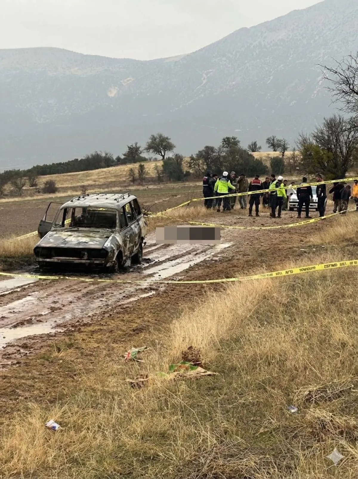 Isparta'da dağlık alanda yanmış bir aracın yakınında, baş kısmı olmayan